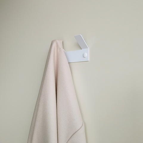 This double wall hook for hanging towels is in a minimal south african bathroom design. 