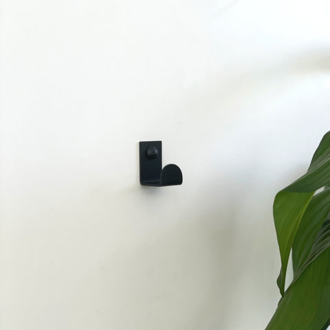 A black wall hook or a black towel hook in a ctm bathroom store in Johannesburg. 