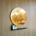 A big beautiful round wall mirror in a luxury bathroom design in Johannesburg. The large round mirror has a reflection of nature. The gold round mirror hangs above a black steel shelf. The shelf for bathroom holds two soap dispensers from Mr Price Home