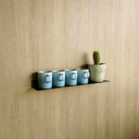 Black steel wall shelf for kitchen with le creuset mugs and indoor plant from Mr Price Home in Johannesburg design store