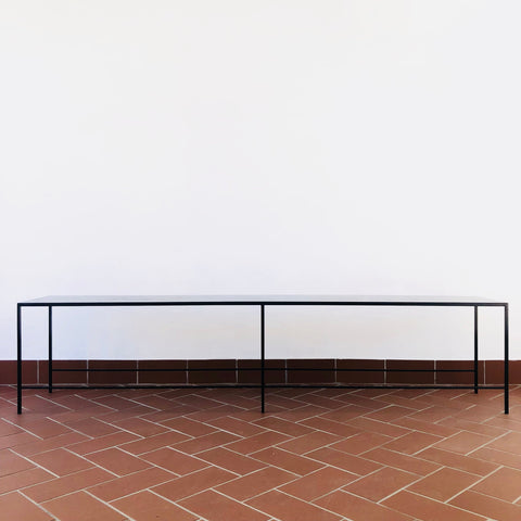 A black steel outdoor dining bench or black steel patio dining bench by South African furniture Designer Monique Vee at a Johannesburg furniture design store