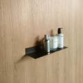 a black steel shelf or black metal bathroom shelf in a luxury bathroom design in johannesburg.  the black metal towel shelf holds a soap dispenser from Mr Price Home and a candle from Mr Price home. The bathroom shelf also holds a stainless steel soap bottle.